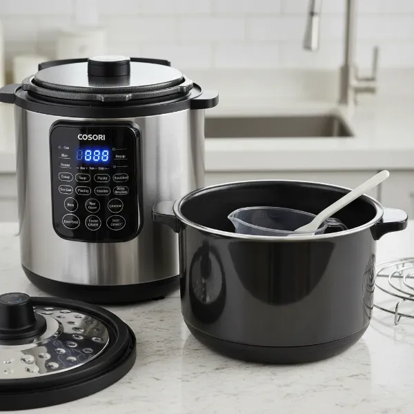 Cosori electric pressure cooker with sleek stainless steel housing and ceramic nonstick inner pot.