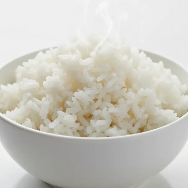A close-up image of perfectly cooked, fluffy white rice in a serving bowl, ready to be enjoyed.