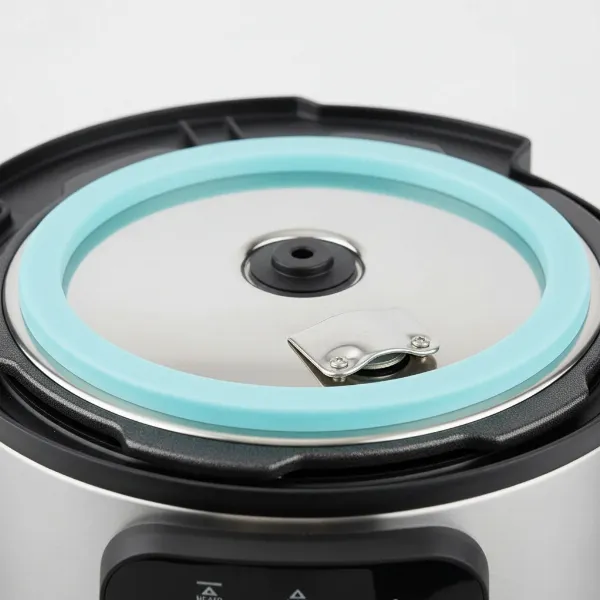 A close-up view of an electric pressure cooker lid, emphasizing the proper placement and condition of the sealing gasket to prevent E3 errors. 