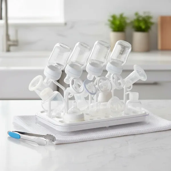 Clean, sterilized baby bottles, nipples, and pump parts air-drying on a hygienic rack.